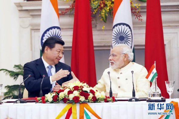 President Xi Jinping and Indian Prime Minister Narendra Modi shake hands at a press conference in New Delhi, India, Sept 18, 2014. (Photo/Xinhua) President Xi Jinping and Indian Prime Minister Narendra Modi shake hands at a press conference in New Delhi, India, Sept 18, 2014. (Photo/Xinhua)