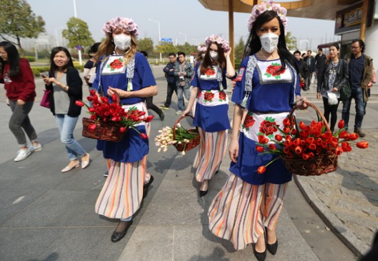 Performers hand out tulips to passersby in an attempt to improve public awareness about environmental protection in Nanjing, Jiangsu province, in March. (Yang Bo/China News Service) Performers hand out tulips to passersby in an attempt to improve public awareness about environmental protection in Nanjing, Jiangsu province, in March. (Yang Bo/China News Service)