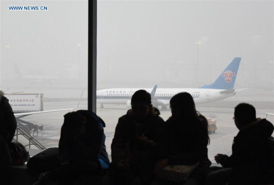 Passengers wait at Beijing Capital Airport in Beijing, capital of China, Dec. 25, 2015. Some flights were delayed due to the orange alert smog on Friday. (Xinhua) Passengers wait at Beijing Capital Airport in Beijing, capital of China, Dec. 25, 2015. Some flights were delayed due to the orange alert smog on Friday. (Xinhua)