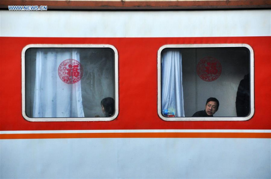 Passengers take a train to return home for family reunion at Caohai Railway Station in Guizhou, capital of southwest China's Guizhou Province, Jan. 28, 2016. Over 2.9 billion trips will be made around China during the 40-day Spring Festival travel rush from Jan. 24 to March 3. (Photo: Xinhua/Yang Wenbin) Passengers take a train to return home for family reunion at Caohai Railway Station in Guizhou, capital of southwest China's Guizhou Province, Jan. 28, 2016. Over 2.9 billion trips will be made around China during the 40-day Spring Festival travel rush from Jan. 24 to March 3. (Photo: Xinhua/Yang Wenbin)