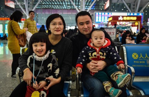 Mr. Zhao, a migrant worker from east China's Shandong Province, waits for train with his wife, 4-year-old daughter and 16-month-old son at Shenzhen Railway Station in Shenzhen, south China's Guangdong Province, Feb. 5, 2016. Lots of migrant workers come back home for family union with their children during the Spring Festival. (Xinhua/Mao Siqian) Mr. Zhao, a migrant worker from east China's Shandong Province, waits for train with his wife, 4-year-old daughter and 16-month-old son at Shenzhen Railway Station in Shenzhen, south China's Guangdong Province, Feb. 5, 2016. Lots of migrant workers come back home for family union with their children during the Spring Festival. (Xinhua/Mao Siqian)