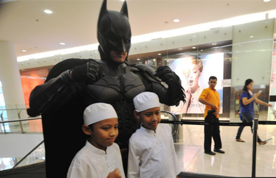 Children pose with a man wearing costumes of animation character of Batman at a shopping center as part of Batman 75th anniversary exhibition in Jakarta, Indonesia, June 27, 2014. (Xinhua file photo/Agung Kuncahya B.) Children pose with a man wearing costumes of animation character of Batman at a shopping center as part of Batman 75th anniversary exhibition in Jakarta, Indonesia, June 27, 2014. (Xinhua file photo/Agung Kuncahya B.)