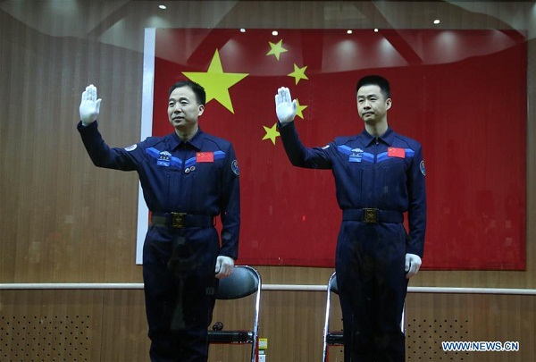 Chinese astronauts Jing Haipeng (L) and Chen Dong meet the media at a press conference at the Jiuquan Satellite Launch Center in northwest China, Oct. 16, 2016. The two male astronauts will carry out the Shenzhou-11 mission. The Shenzhou-11 manned spacecraft will be launched at 7:30 a.m. Oct. 17, 2016 Beijing Time (2330 GMT Oct. 16). (Xinhua/Li Gang) Chinese astronauts Jing Haipeng (L) and Chen Dong meet the media at a press conference at the Jiuquan Satellite Launch Center in northwest China, Oct. 16, 2016. The two male astronauts will carry out the Shenzhou-11 mission. The Shenzhou-11 manned spacecraft will be launched at 7:30 a.m. Oct. 17, 2016 Beijing Time (2330 GMT Oct. 16). (Xinhua/Li Gang)