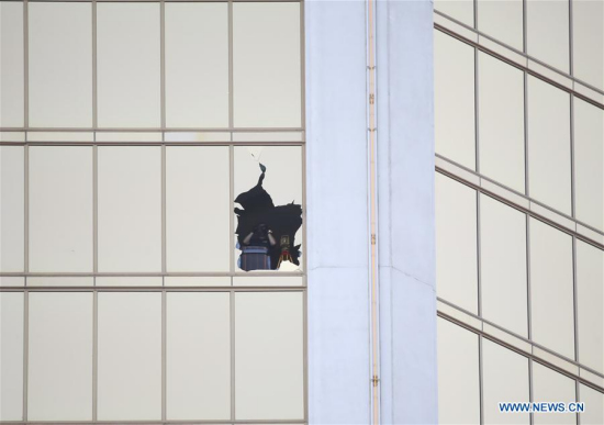 An investigator is seen from one of the broken windows of Mandalay Bay Resort in Las Vegas, the United States, Oct. 4, 2017. (Xinhua/Wang Ying) An investigator is seen from one of the broken windows of Mandalay Bay Resort in Las Vegas, the United States, Oct. 4, 2017. (Xinhua/Wang Ying)