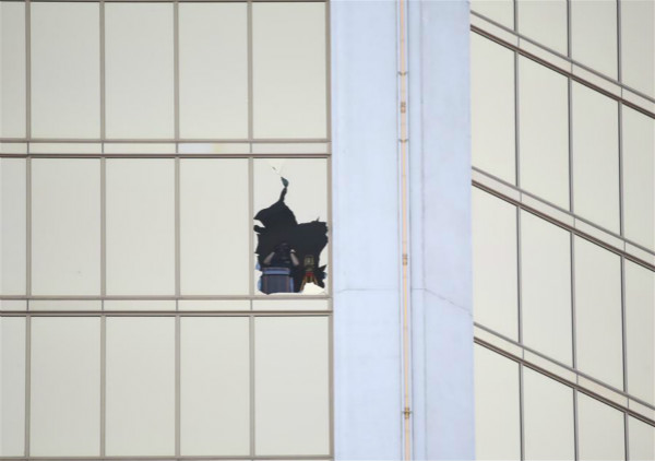 An investigator is seen from one of the broken windows of Mandalay Bay Resort in Las Vegas, the United States, Oct. 4, 2017. (Xinhua/Wang Ying) An investigator is seen from one of the broken windows of Mandalay Bay Resort in Las Vegas, the United States, Oct. 4, 2017. (Xinhua/Wang Ying)