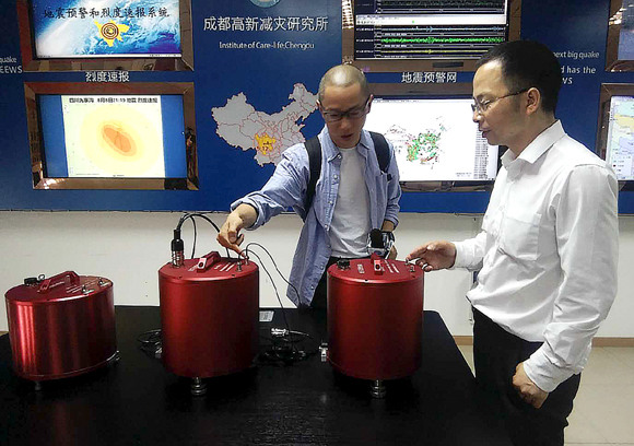 Wang Tun (right), head of the Chengdu-based Institute of Care-Life, demonstrates a seismic monitoring station. (Photo: China Daily/Huang Zhiling) Wang Tun (right), head of the Chengdu-based Institute of Care-Life, demonstrates a seismic monitoring station. (Photo: China Daily/Huang Zhiling)
