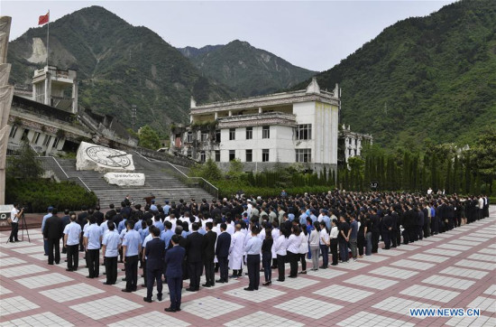 People gather at the ruined site of Xuankou Middle School as they participate in a memorial ceremony marking the 10th anniversary of the Wenchuan Earthquake in Yingxiu Township of Wenchuan County, southwest China's Sichuan Province, May 12, 2018.(Xinhua/Liu Kun) People gather at the ruined site of Xuankou Middle School as they participate in a memorial ceremony marking the 10th anniversary of the Wenchuan Earthquake in Yingxiu Township of Wenchuan County, southwest China's Sichuan Province, May 12, 2018.(Xinhua/Liu Kun)