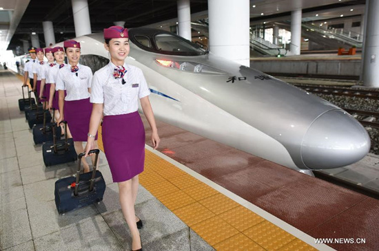 Train attendants prepare to board a CH380 high-speed train at the Guiyang North Railway Station in Guiyang, capital of southwest China's Guizhou Province, June 17, 2015. The 286-kilometer-long Guiyang-Xinhuang section of the Shanghai-Kunming High-Speed Railway linking east China's Shanghai and Kunming, capital of southwest China's Yunnan Province, is scheduled to come on stream on June 18. (Xinhua/Liu Xu) Train attendants prepare to board a CH380 high-speed train at the Guiyang North Railway Station in Guiyang, capital of southwest China's Guizhou Province, June 17, 2015. The 286-kilometer-long Guiyang-Xinhuang section of the Shanghai-Kunming High-Speed Railway linking east China's Shanghai and Kunming, capital of southwest China's Yunnan Province, is scheduled to come on stream on June 18. (Xinhua/Liu Xu)