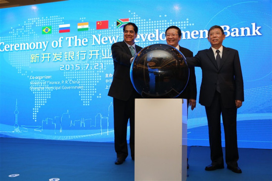 Shanghai Mayor Yang Xiong (R), Chinese Finance Minister Lou Jiwei (M) and K.V. Kamath, president of the New Development Bank(L), celebrate together as the New Development Bank, more commonly known as the BRICS Bank, was officially launched in Shanghai today. (Photo:Shanghai Daily/Wang Rongjiang) Shanghai Mayor Yang Xiong (R), Chinese Finance Minister Lou Jiwei (M) and K.V. Kamath, president of the New Development Bank(L), celebrate together as the New Development Bank, more commonly known as the BRICS Bank, was officially launched in Shanghai today. (Photo:Shanghai Daily/Wang Rongjiang)