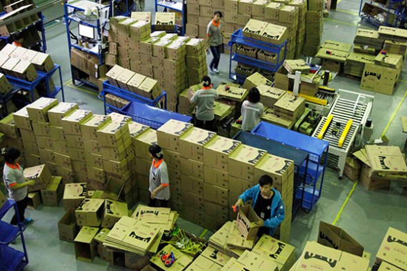 Workers from Tmall.com prepare cartons for goods that need to be sent by post at a sorting center in Guangzhou, Guangdong province. According to iResearch Consulting Group, Tmall led China's B2C market in the first quarter of this year, accounting for 58.6 percent of the 373.7 billion yuan ($61.02 billion) market between January and March. (Photo: China Daily) Workers from Tmall.com prepare cartons for goods that need to be sent by post at a sorting center in Guangzhou, Guangdong province. According to iResearch Consulting Group, Tmall led China's B2C market in the first quarter of this year, accounting for 58.6 percent of the 373.7 billion yuan ($61.02 billion) market between January and March. (Photo: China Daily)