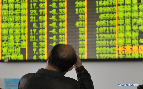 An investor looks through stock information at a trading hall in a securities firm in Hangzhou, capital of east China's Zhejiang Province, Jan. 7, 2016. (Photo/Xinhua) An investor looks through stock information at a trading hall in a securities firm in Hangzhou, capital of east China's Zhejiang Province, Jan. 7, 2016. (Photo/Xinhua)