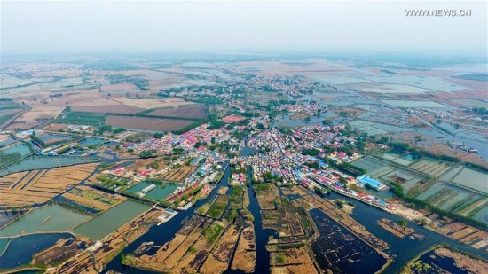 Photo taken on April 9, 2017 shows a village in Baiyangdian, one of the largest freshwater wetlands in north China, in Anxin County, north China's Hebei Province. China announced the plan for Xiongan New Area officially on April 1, 2017. The new area will span Xiongxian, Rongcheng and Anxin counties in Hebei Province, eventually covering 2,000 square kilometers. (Xinhua/Mou Yu) Photo taken on April 9, 2017 shows a village in Baiyangdian, one of the largest freshwater wetlands in north China, in Anxin County, north China's Hebei Province. China announced the plan for Xiongan New Area officially on April 1, 2017. The new area will span Xiongxian, Rongcheng and Anxin counties in Hebei Province, eventually covering 2,000 square kilometers. (Xinhua/Mou Yu)