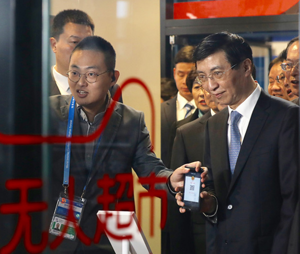 Wang Huning, a member of the Standing Committee of the CPC Central Committee Political Bureau, visits a self-service supermarket during the 4th World Internet Conference in Wuzhen, Zhejiang province, on Dec 3, 2017. ZHU XINGXIN/CHINA DAILY Wang Huning, a member of the Standing Committee of the CPC Central Committee Political Bureau, visits a self-service supermarket during the 4th World Internet Conference in Wuzhen, Zhejiang province, on Dec 3, 2017. ZHU XINGXIN/CHINA DAILY