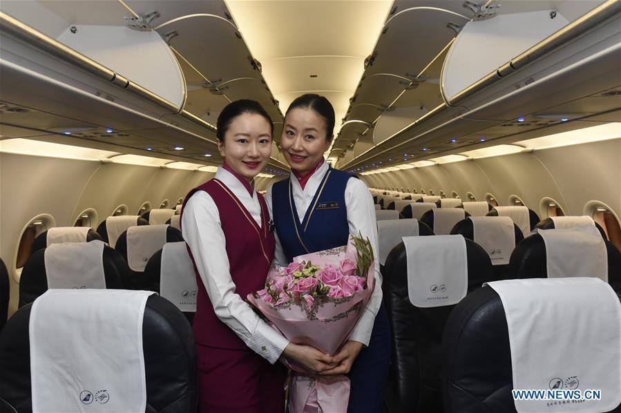 <p>Zhu Aijun (R) and her daughter Li Xinyun pose for photos in the cabin in Shenyang, capital of northeast China's Liaoning Province, Nov. 17, 2017. Zhu Aijun has been a flight attendant in China Southern Airlines since 1987, and Friday is her last flight before retirement. Her daughter Li Xinyun, who became a flight attendant in 2016, has been permitted to fly with her mother. (Xinhua/Long Lei)</p>