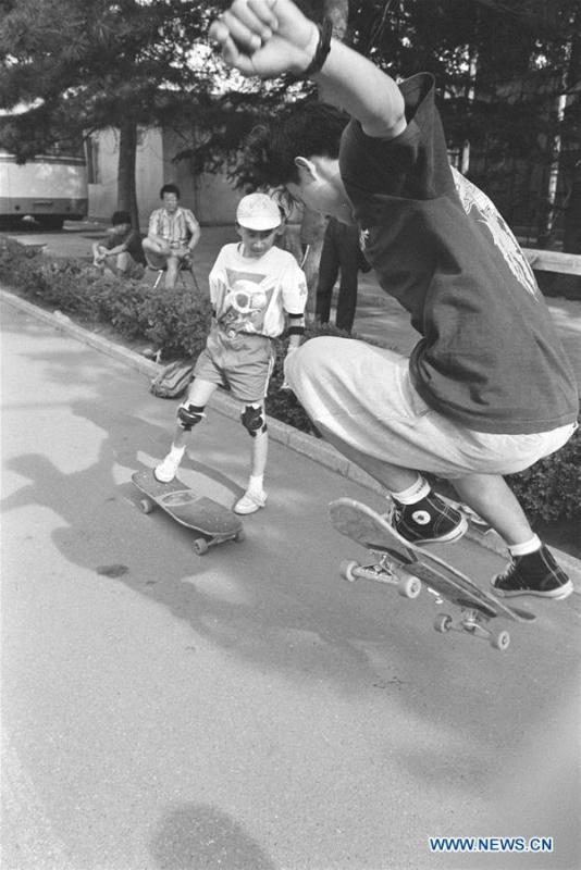In this file photo issued on August 1, 1994, two boys practise skateboard in a square in Beijing, capital of China. As China celebrates the International Children\'s Day, there arises the occasion for grown-ups to think back over the joys of childhood. With the evolution of technology and lifestyle, children are exposed to a wider range of entertainment. Nevertheless, joy would remain a childhood motif no matter how its forms change with time. (Xinhua/Zhang Xu)