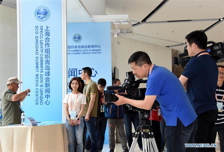 A cameraman works at the media center for the 18th Shanghai Cooperation Organization (SCO) Summit in Qingdao, east China\'s Shandong Province, June 6, 2018. The center will be open to journalists from both home and abroad from June 6 to 11. (Xinhua/Li Ziheng)