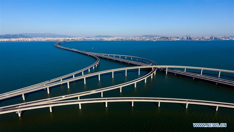 Aerial photo taken on June 1, 2018 shows the Qingdao Jiaozhou Bay Bridge in Qingdao, east China\'s Shandong Province. The 36.48-km cross-sea bridge connects the urban district of Qingdao City to its Huangdao district. (Xinhua/Guo Xulei)