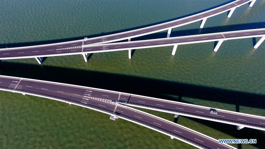 Aerial photo taken on June 1, 2018 shows the Qingdao Jiaozhou Bay Bridge in Qingdao, east China\'s Shandong Province. The 36.48-km cross-sea bridge connects the urban district of Qingdao City to its Huangdao district. (Xinhua/Guo Xulei)