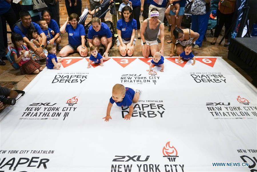 Babies participate in the Diaper Derby 2018 in New York, the United States, June 29, 2018. Diaper Derby 2018, a baby crawling contest, was held here on Friday. Around 30 babies competed to crawl across a 12-foot (3.66 meters) long mat. (Xinhua/Lin Bilin)