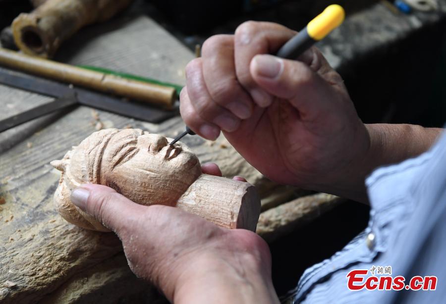 Folk artist Yang Yazhou makes a puppet head in his studio in Zhangzhou City, East China’s Fujian Province, July 1, 2018. Zhangzhou has a history of puppetry going back more than two thousand years. Yang represents the fifth generation of his family to be involved with Fuchun-style glove puppets show, an intangible cultural heritage. He began learning to carve puppet heads when he was nine years old, taught by several masters. Yang said it takes tens of steps to finish carving a puppet-head in about three days. Yang’s sister specializes in dressing the puppets, his brother in puppet performance. (Photo: China News Service/Zhang Bin)