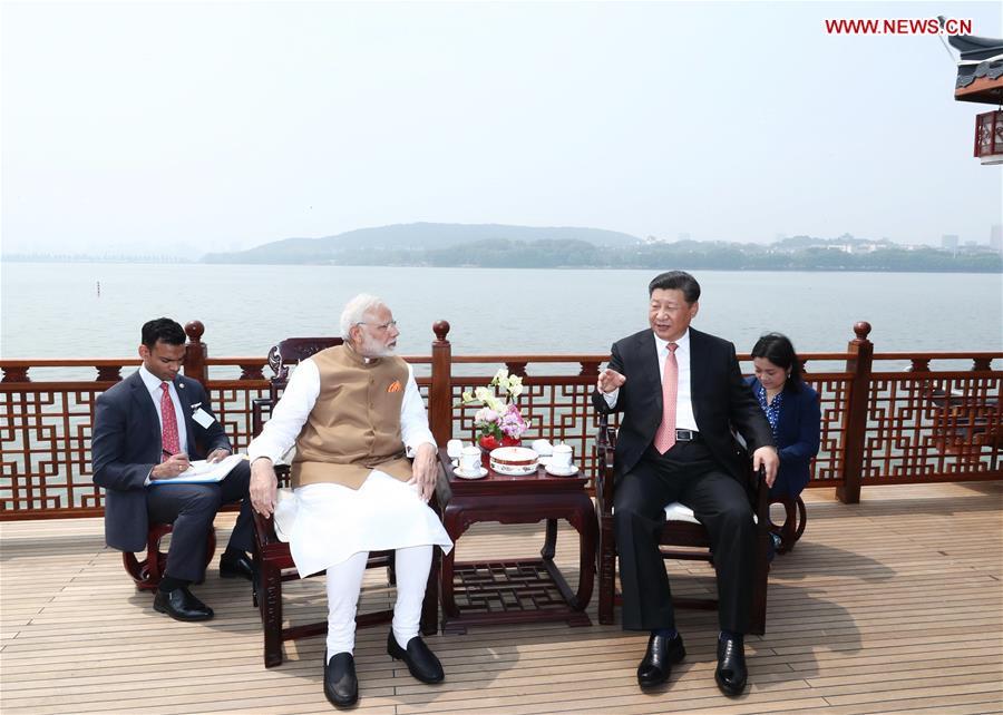 April 28, 2018
President Xi Jinping talks with Indian Prime Minister Narendra Modi in Wuhan, Central China\'s Hubei Province, ahead of the start of the Shanghai Cooperation Organization summit in June and at an important juncture for the progress of China-India relations. (Photo/Xinhua)
During the meeting, Xi and Modi tried two types of local tea, Lichuan black tea and Enshi green tea. Xi also mentioned that another type of tea from Yichang, Hubei, had ties with India. With exchanges between China and India in trade and culture dating far back, President Xi emphasized that China and India should expand and deepen exchanges, be committed to the rejuvenation of Eastern civilization, call for respect for cultural diversity, and promote the harmonious coexistence of different civilizations.