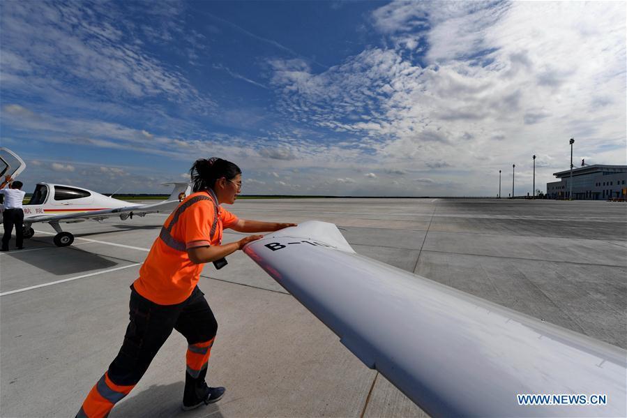 Deng Yun pushes an aircraft to a specific place at the Chagan Lake airport in Songyuan, northeast China\'s Jilin Province, July 17, 2018. Deng was born in 1991. She is an aircraft maintenance technician of an aviation academy in Jilin. The young female engineer and other nine colleagues are in charge of training plane maintenance at the airport. To ensure the flight safety, they need to check more than 100 items before a plane takes off. (Xinhua/Zhang Nan)