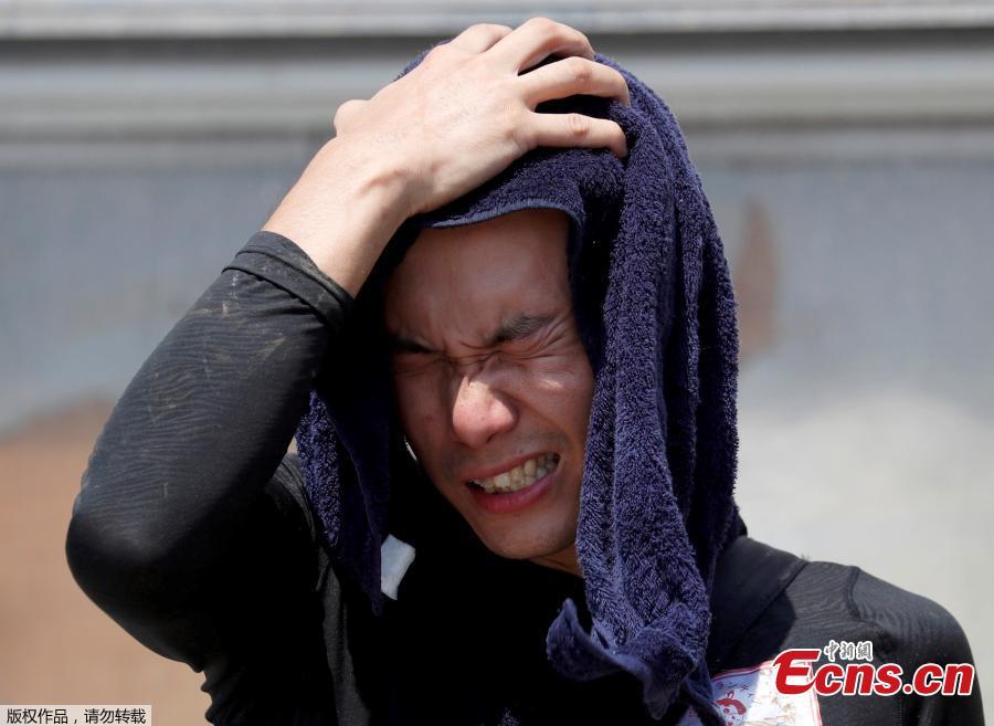 A volunteer, for recovery work, wipes his sweat as he takes a break in a heat wave at a flood affected area in Kurashiki, Okayama Prefecture, Japan, July 14, 2018. (Photo/Agencies)