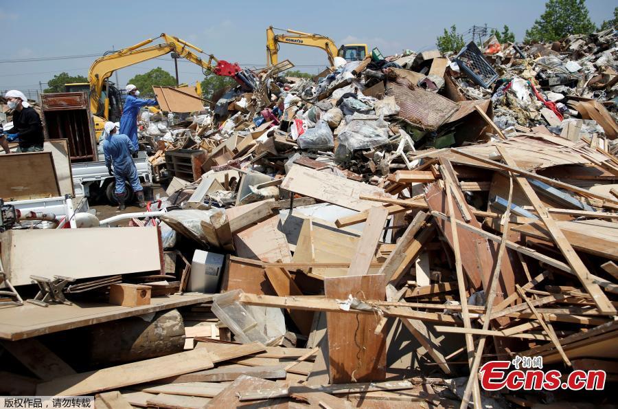 Local residents pile up household waste, caused by a flooding, at a temporary waste-collection point in Kurashiki, Okayama Prefecture, Japan, July 14, 2018. (Photo/Agencies)