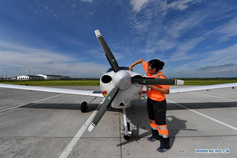 Deng Yun checks an aircraft at the Chagan Lake airport in Songyuan, northeast China\'s Jilin Province, July 17, 2018. Deng was born in 1991. She is an aircraft maintenance technician of an aviation academy in Jilin. The young female engineer and other nine colleagues are in charge of training plane maintenance at the airport. To ensure the flight safety, they need to check more than 100 items before a plane takes off. (Xinhua/Zhang Nan)