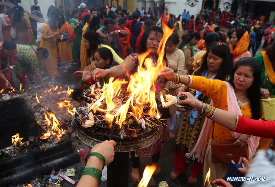 Hindu women offer prayers on Shrawan Somvar at Pashupatinath Temple in Kathmandu, Nepal, July 23, 2018. Mondays in the holy month of Shrawan are considered auspicious for Hindu women as they fast and offer prayers to Lord Shiva for the long and prosperous life for their husbands. (Xinhua/Sunil Sharma)