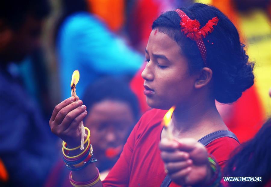 A Hindu girl offers prayers on Shrawan Somvar at Pashupatinath Temple in Kathmandu, Nepal, July 23, 2018. Mondays in the holy month of Shrawan are considered auspicious for Hindu women as they fast and offer prayers to Lord Shiva for the long and prosperous life for their husbands. (Xinhua/Sunil Sharma)