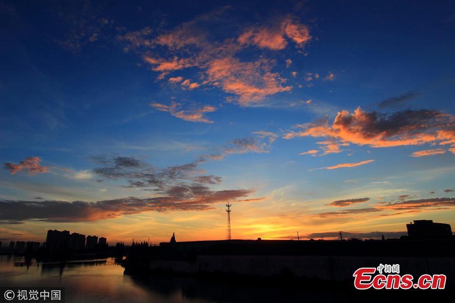 Crimson clouds at sunset hang over the sky in Shaoxing City, Zhejiang Province, Aug. 14, 2018, after the typhoon Yagi. (Photo/VCG)