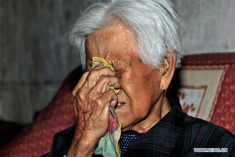 97-year-old Liu Gailian sheds tears as she speaks out her experiences as a \