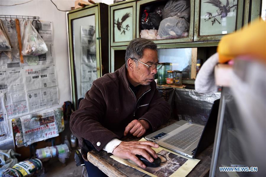 Zhang Shuangbing looks at the screen of his laptop on March 2, 2016. For more than 10 years Zhang Shuangbing, a retired Chinese village teacher, painstakingly recorded the heart-wrenching experiences of 129 Chinese women who were forced into sexual slavery by Japanese invaders during World War II. Women forced into sexual slavery by the Imperial Japanese Army before and during World War II were called \