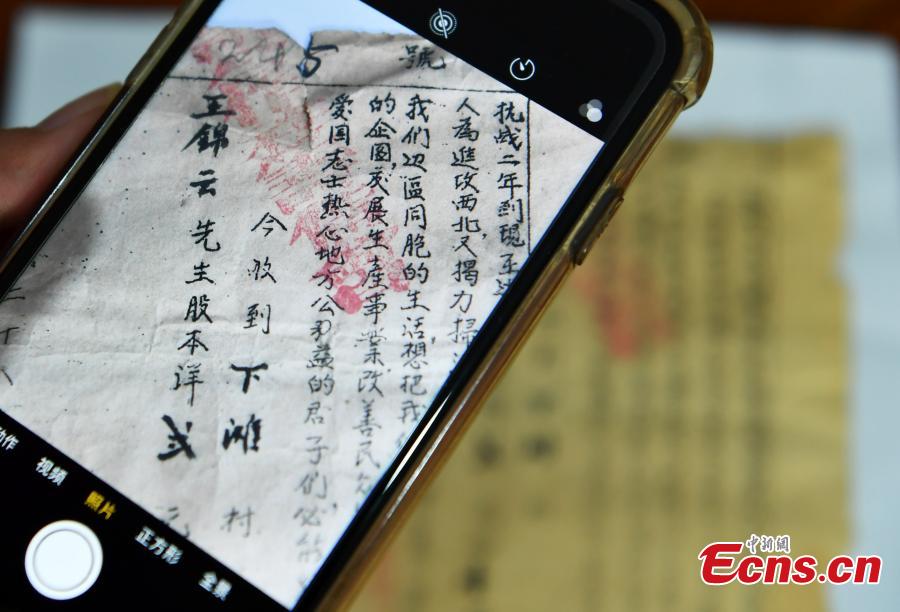 Wang Zhiliang shows a stock certificate issued in 1939 in Xiatan Village, Pingshan County, North China’s Hebei Province, Sept. 11, 2018. Wang said his grandfather, Wang Jinyun, purchased the stock to support the war against Japanese aggression in 1939, issued by the local government of the time. (Photo: China News Service/Zhai Yujia)