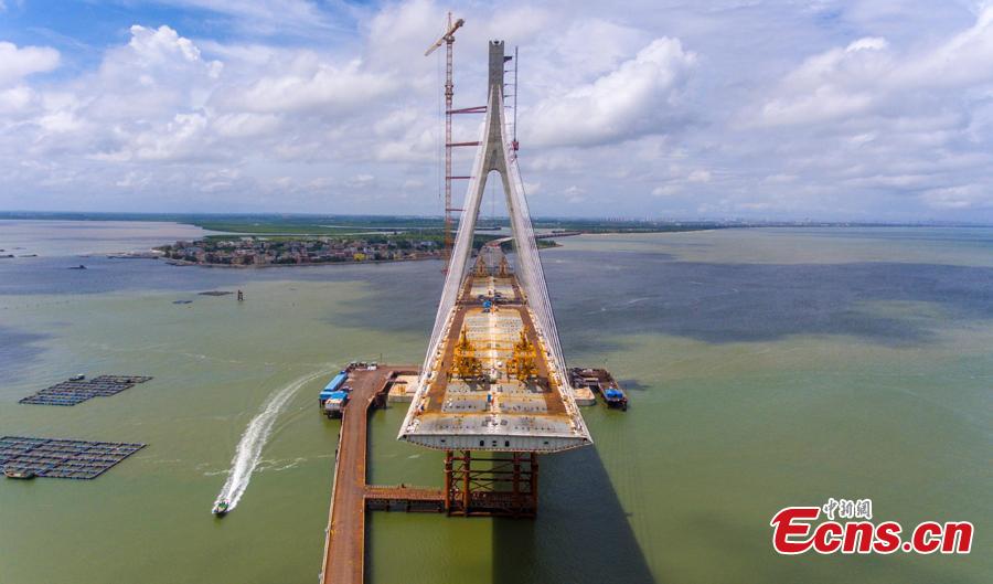 A view of the Puqian Bridge under construction in South China\'s Hainan Province, Sept. 14, 2018. Construction of the cross-sea bridge, scheduled for completion at the end of 2018, will cut the trip from Wenchang City to Haikou City from 90 minutes to about 20 minutes. Spanning a geological fault line, it’s being built to the highest standard of earthquake resistance at an investment of 3.01 billion yuan ($440 million). The 5.6-km-long bridge is expected to promote economic growth in the northern part of Hainan Province. (Photo: China News Service/Luo Yunfei)