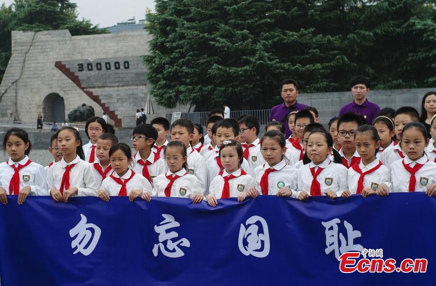 Students mourn the deceased in silence at the Memorial Hall of the Victims in Nanjing Massacre by Japanese Invaders in Nanjing City, Jiangsu Province, Sept. 18, 2018. On September 18, 1931, the Japanese Kwantung Army stationed in northeast China destroyed a section of the railway near Liutiaohu and then falsely accused the Chinese military of causing the explosion. Using this as a pretext, the Japanese then bombarded Shenyang and began invasion of northeast China. (Photo: China News Service/Yang Bo)