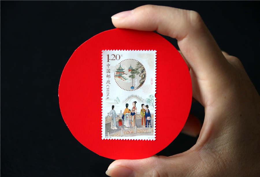 A stamp collector shows the newly issued stamp themed on the Mid-Autumn Festival, in Zaozhuang city, Shandong Province, Sept. 15, 2018. (Photo/Asianewsphoto)
China Post issued a set of stamp to celebrate the upcoming Mid-Autumn Festival on Sept. 15. The set, designed by Cui Jingzhe, comprises one stamp and has a nominal value of 1.2 yuan (around $0.2).
As the second set themed on the Mid-Autumn Festival following the 2016 stamp, this one continues the art technique of traditional gongbi (meticulous brush strokes) style. The upper part of the stamp shows the legend of Jade Rabbit pounding medicine, which symbolizes the wishes for a healthy and safe body, happiness and longevity. The lower part of the stamp portrays the folk custom of \