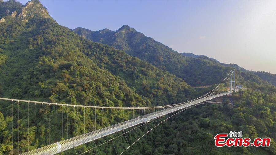 A drone photo shows a 379-meter-long glass bridge built in the Nandan Mountain area in Foshan City, South China’s Guangdong Province, which opened on Sept. 28, 2018 after passing safety test. The glass bridge, suspended 202 meters above the ground, makes use of innovative technology to create impressive sound and visual effects. (Photo: China News Service/Zeng Linghua)