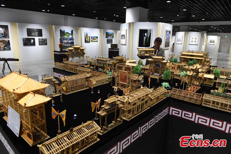 Craftsman Wu Tianxiang shows a replica of Fuxi Temple in Tianshui City made using bamboo sticks during the Silk Road (Dunhuang) International Cultural Expo in Dunhuang City, Northwest China’s Gansu Province, Sept. 28, 2018. It took Wu five years and 20,000 bamboo sticks to create the miniaturized landscape that measured 4.8 meters long and 4.2 meters wide and included 58 buildings in great details. Each door and window in the model can be opened easily. (Photo: China News Service/Yang Yanmin)