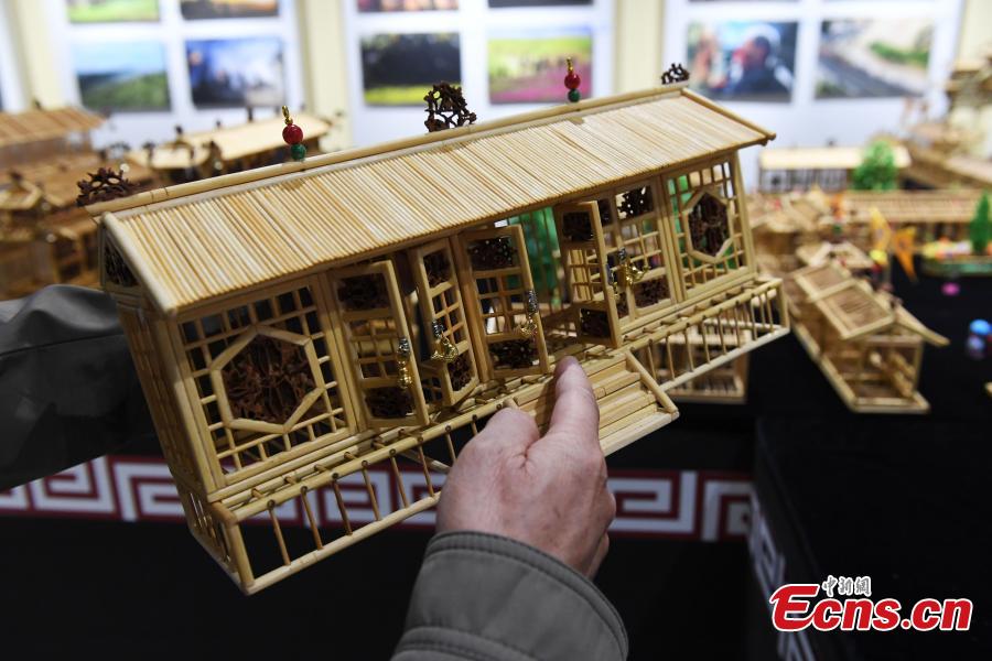 Craftsman Wu Tianxiang shows a replica of Fuxi Temple in Tianshui City made using bamboo sticks during the Silk Road (Dunhuang) International Cultural Expo in Dunhuang City, Northwest China’s Gansu Province, Sept. 28, 2018. It took Wu five years and 20,000 bamboo sticks to create the miniaturized landscape that measured 4.8 meters long and 4.2 meters wide and included 58 buildings in great details. Each door and window in the model can be opened easily. (Photo: China News Service/Yang Yanmin)