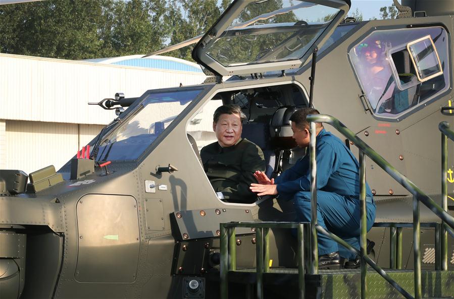 Chinese President Xi Jinping, also general secretary of the Communist Party of China (CPC) Central Committee and chairman of the Central Military Commission, boards a Z-10 helicopter and manipulates the airborne weapon and aiming system during his inspection, Sept. 27, 2018. Xi inspected the 79th Group Army of the People\'s Liberation Army and met with senior officers of troops stationed in northeast China\'s Liaoning Province from Sept. 27 to 28. (Xinhua/Li Gang)