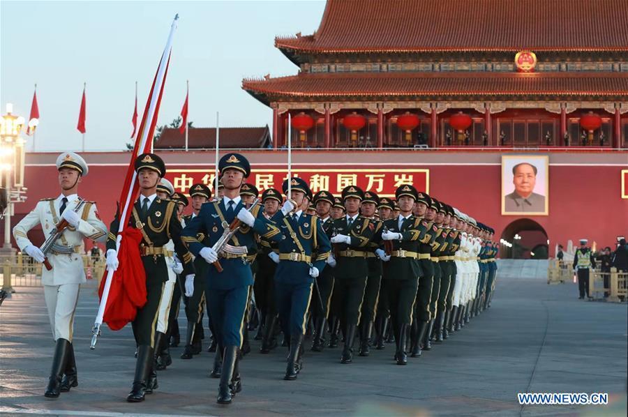 The guard of honor escorts the national flag for a national flag-raising ceremony in a celebration of the National Day at the Tian\'anmen Square in central Beijing, capital of China, on Oct. 1, 2018, the 69th anniversary of the founding of the People\'s Republic of China. (Xinhua/Ju Zhenhua)