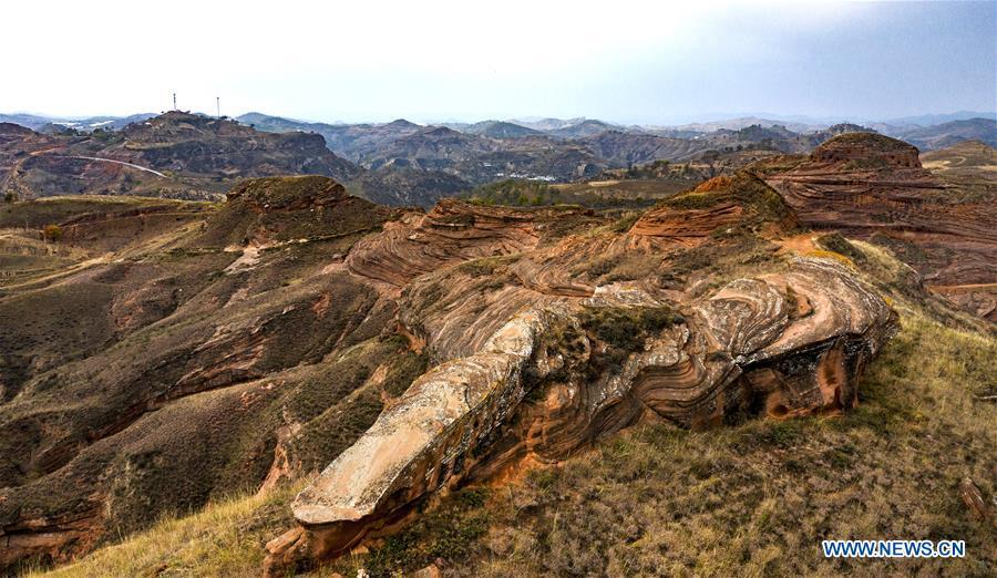 Aerial photo taken on Oct. 21, 2018 shows a view of Danxia landform at Wangjiawan of Pingqiao Town in Ansai District of Yan\'an, northwest China\'s Shaanxi Province. Danxia landform is a unique type of geomorphology formed from red-colored sandstones and characterized by steep cliffs. (Xinhua/Tao Ming)