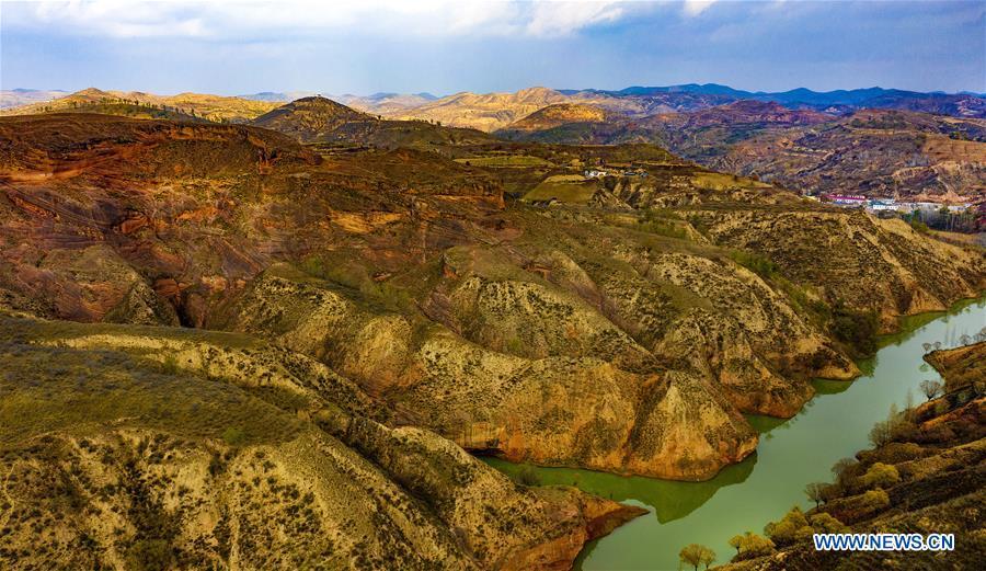 Aerial photo taken on Oct. 21, 2018 shows a view of Danxia landform at dusk at Wangjiawan of Pingqiao Town in Ansai District of Yan\'an, northwest China\'s Shaanxi Province. Danxia landform is a unique type of geomorphology formed from red-colored sandstones and characterized by steep cliffs. (Xinhua/Tao Ming)