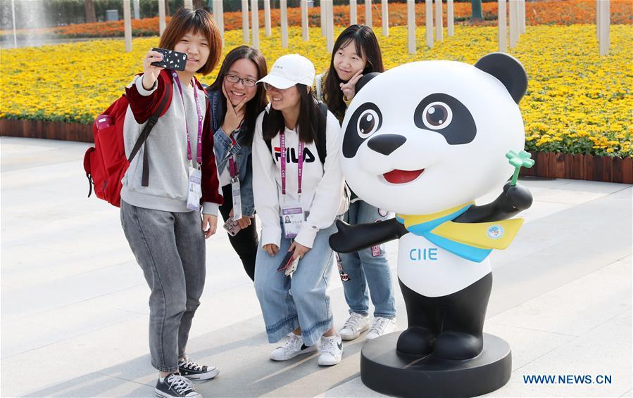 Volunteers for the upcoming China International Import Expo (CIIE) pose for a photo with the mascot \
