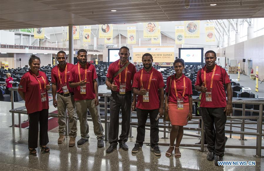 Staff pose for a group photo at the APEC 2018 International Media Centre in Port Moresby, Papua New Guinea (PNG), on Nov. 13, 2018. PNG, comprising about 600 small islands, is the host of the APEC meetings this year. The media center opened to journalists on Monday and will be in use until Nov. 18. (Xinhua/Bai Xuefei)