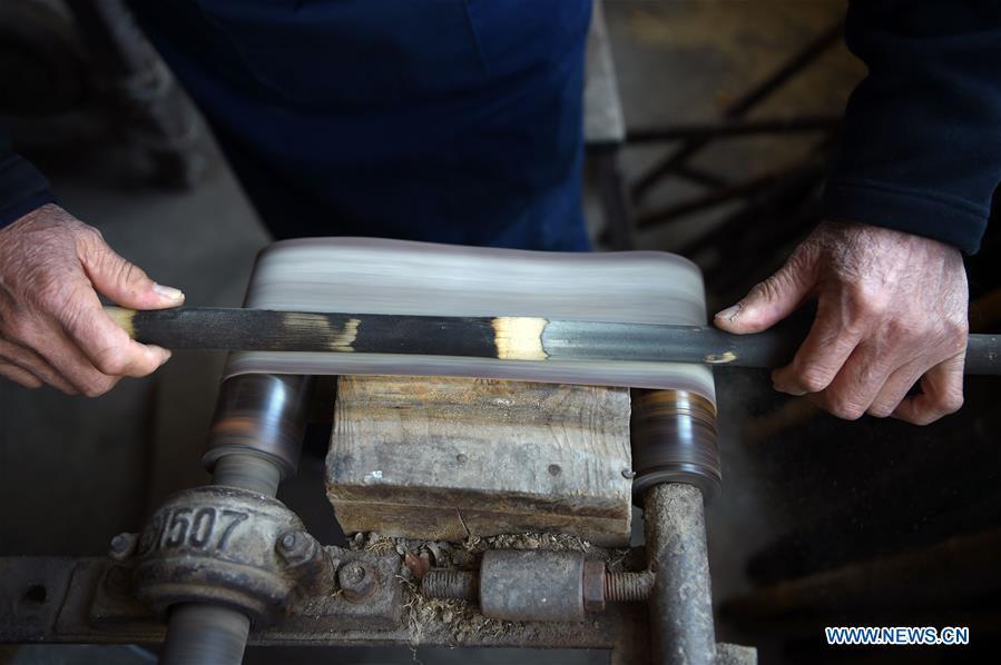 Liu Zesong, inheritor of the Yuping bamboo flute making craft, deals with bamboo materials for making a flute in Yuping Dong Autonomous County, southwest China\'s Guizhou Province, Nov. 29, 2018. As a traditional Chinese bamboo instrument, Yuping bamboo flute is famous for its clear tone and delicate carving. Made from local bamboo, the flute goes through dozens of procedures before finished and merges folk cultures of other ethnic groups. It was listed as one of the National Intangible Cultural Heritages in 2006. (Xinhua/Ma Ning)