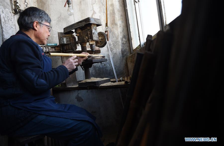 Liu Zesong, inheritor of the Yuping bamboo flute making craft, deals with bamboo materials for making a flute in Yuping Dong Autonomous County, southwest China\'s Guizhou Province, Nov. 29, 2018. As a traditional Chinese bamboo instrument, Yuping bamboo flute is famous for its clear tone and delicate carving. Made from local bamboo, the flute goes through dozens of procedures before finished and merges folk cultures of other ethnic groups. It was listed as one of the National Intangible Cultural Heritages in 2006. (Xinhua/Ma Ning)