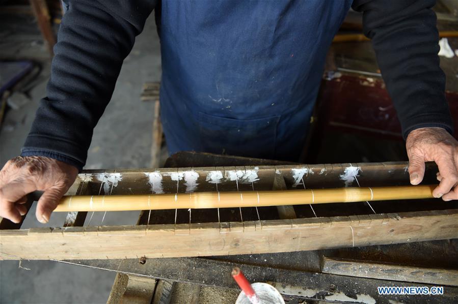Liu Zesong, inheritor of the Yuping bamboo flute making craft, deals with bamboo materials for making a flute in Yuping Dong Autonomous County, southwest China\'s Guizhou Province, Nov. 29, 2018. As a traditional Chinese bamboo instrument, Yuping bamboo flute is famous for its clear tone and delicate carving. Made from local bamboo, the flute goes through dozens of procedures before finished and merges folk cultures of other ethnic groups. It was listed as one of the National Intangible Cultural Heritages in 2006. (Xinhua/Ma Ning)